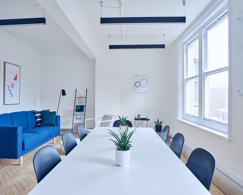 A modern collaborative workspace interior in Monterrey with plants and bright windows